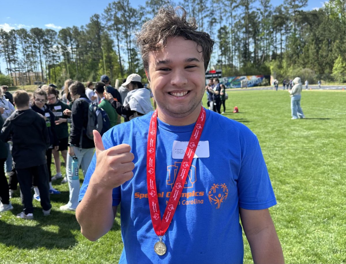 Tobin poses with his gold medal in the 100 meter dash at the 2025 North Carolina Special Olympics. He also won 2nd place in the softball throw.