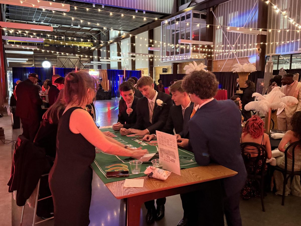 Students are seen playing Vegas themed games at prom. The theme for Prom was a night in Vegas which is why they had this at the dance.
