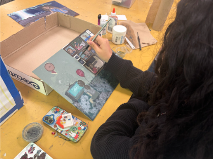 Axzarah Mata working on a painting done with oil paint. One of her five pieces for her portfolio in AP Studio Art at Athens.