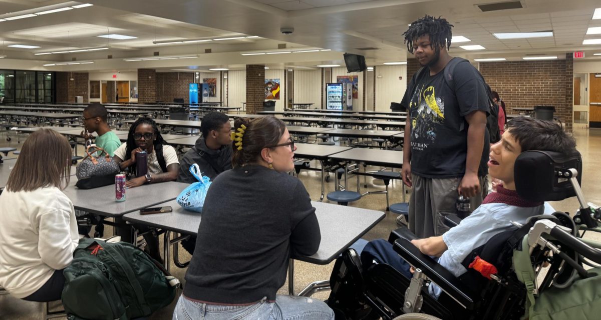 Dy'mir McCutcheon is seen chatting with a few ECS students before school begins. He has made great connections with many of them during his time in PEPI.